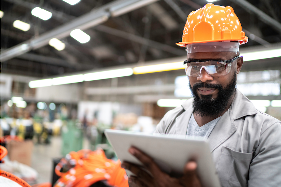 Man on tablet in manufacturing facility